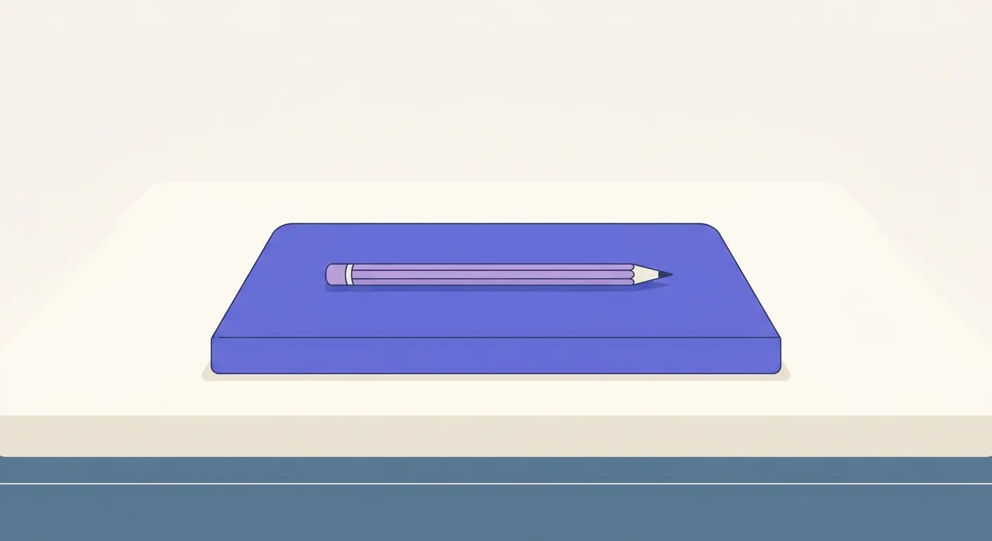 A closed notebook on a wooden desk with a pencil resting on top.